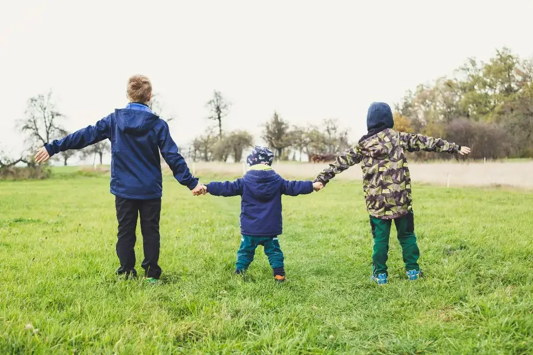 Children playing in greenspace, one reason why a family may consider moving to Germany.