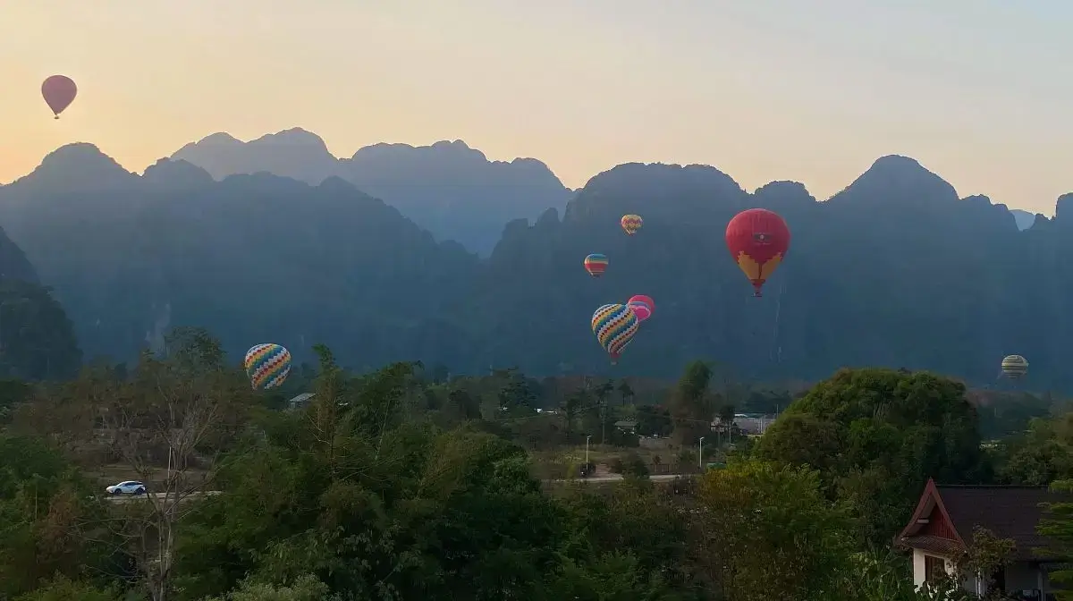 Vang Vieng Mountains at sunset with Hot Air Balloons