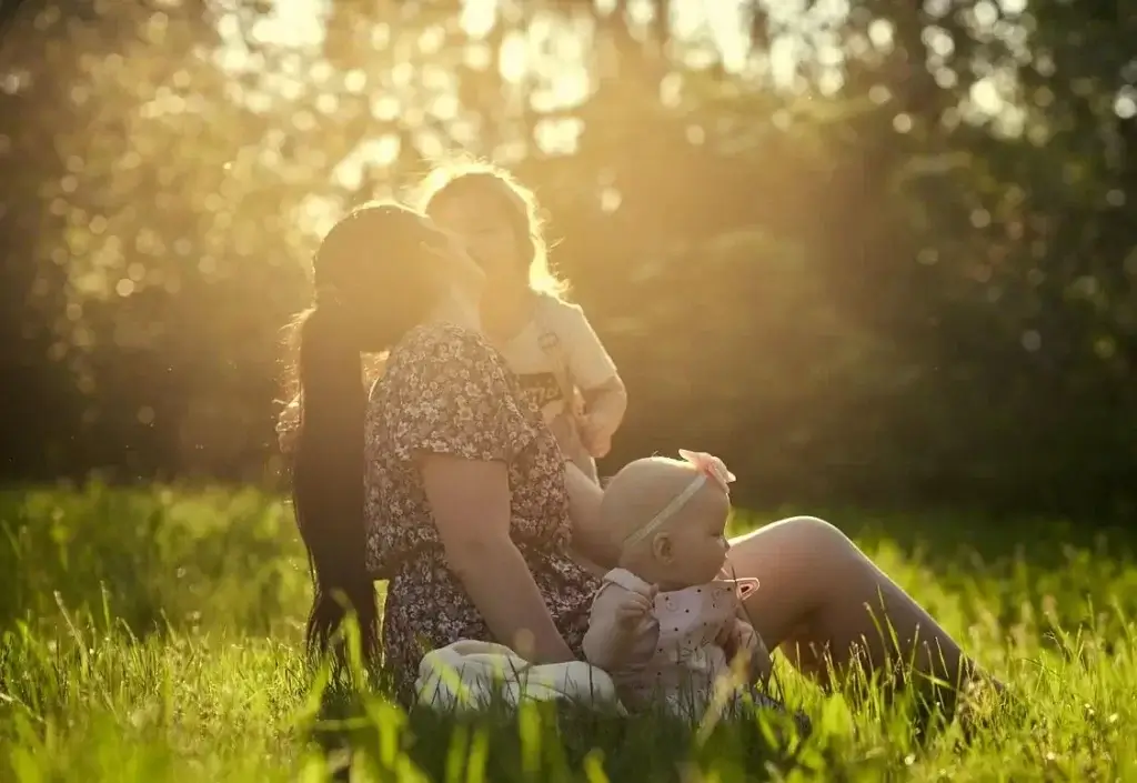 Mother and Children sharing a relaxing moment together in the afternoon autumn German sun.