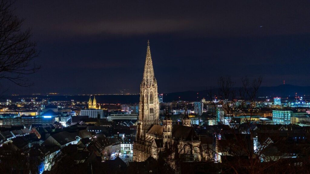 A night view over the city of Freiburg, one of the best cities for expat families in Germany.