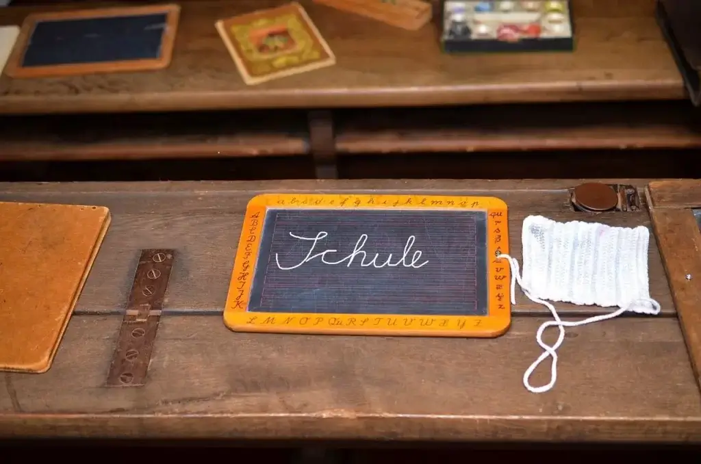 Old-fashioned school desk in Germany with the word "Schule".