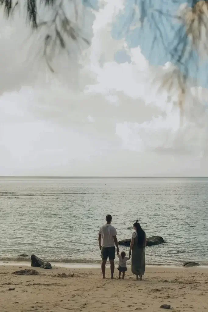Family enjoying the view from the beach over the sea.