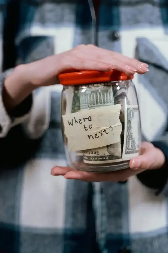 Savings jar with the words "Where to Next?" written inside, indicating the beginning of a family travel budget.