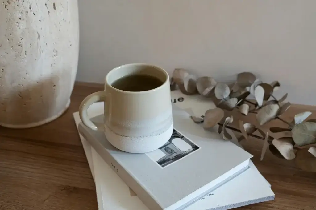 A coffee cup sat on a book, comfort items often forgotten about when families relocate abroad.