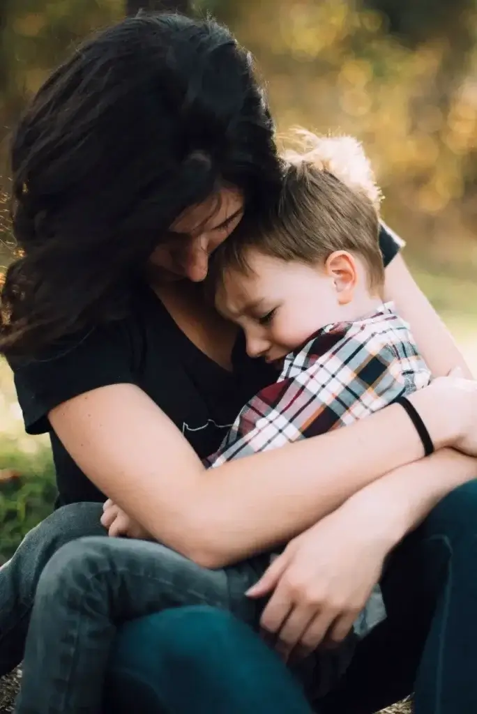 Mother hugging her son after moving abroad together and the emotional impact becoming clear.
