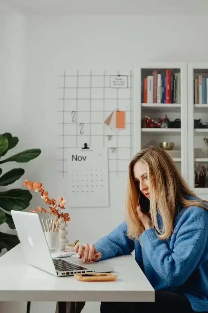 A professional Mother working from her at-home desk, managing the shift in her career since her international relocation.